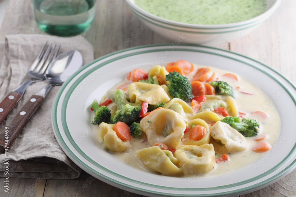 Tortellini with vegetables under cream sauce Tortellini with vegetables under cream sauce