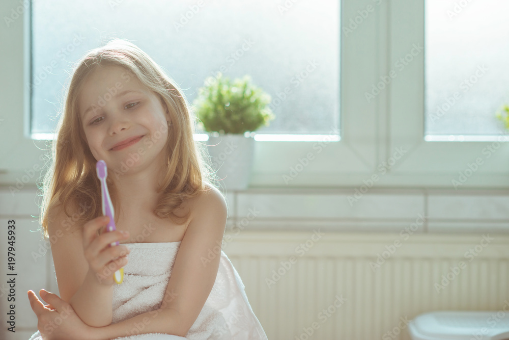 Portrait of pretty little child girl with white towel after shower in bright bathroom Portrait of pretty little child girl with white towel after shower in bright bathroom