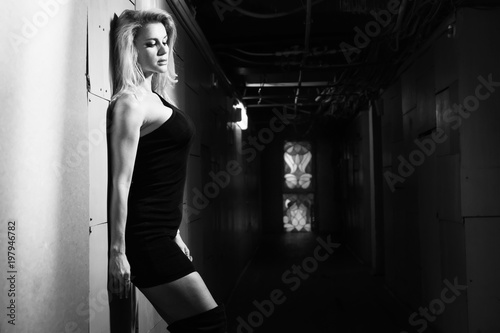 A pretty woman in a dark room © Demian