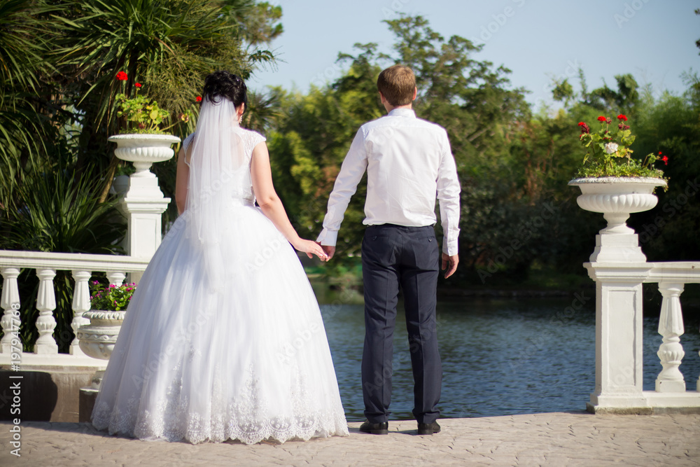 The bride and groom are walking in the park The bride and groom are walking in the park
