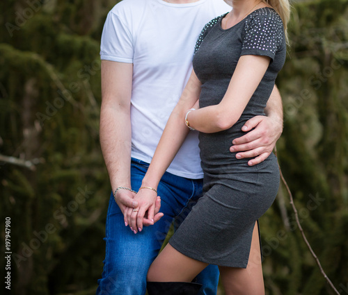 Young couple strolling in summer in the park