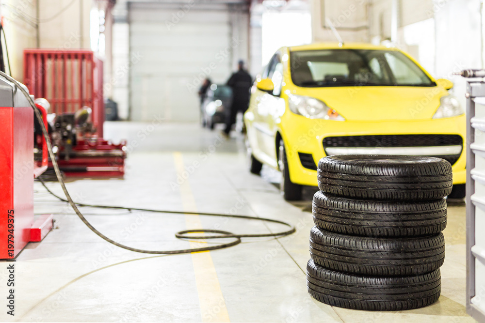 Car maintenance and service center. Vehicle tire repair and replacement equipment. Seasonal tire change Car maintenance and service center. Vehicle tire repair and replacement equipment. Seasonal tire change