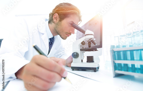 scientist makes a note of experiment in the laboratory