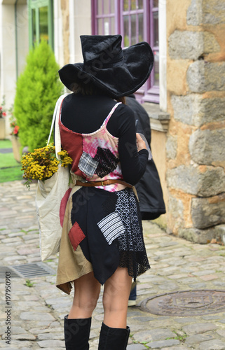 Mysterious girl in witch's clothes and hat