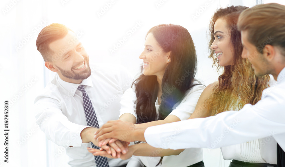 Obraz premium Close-up of business partners making pile of hands
