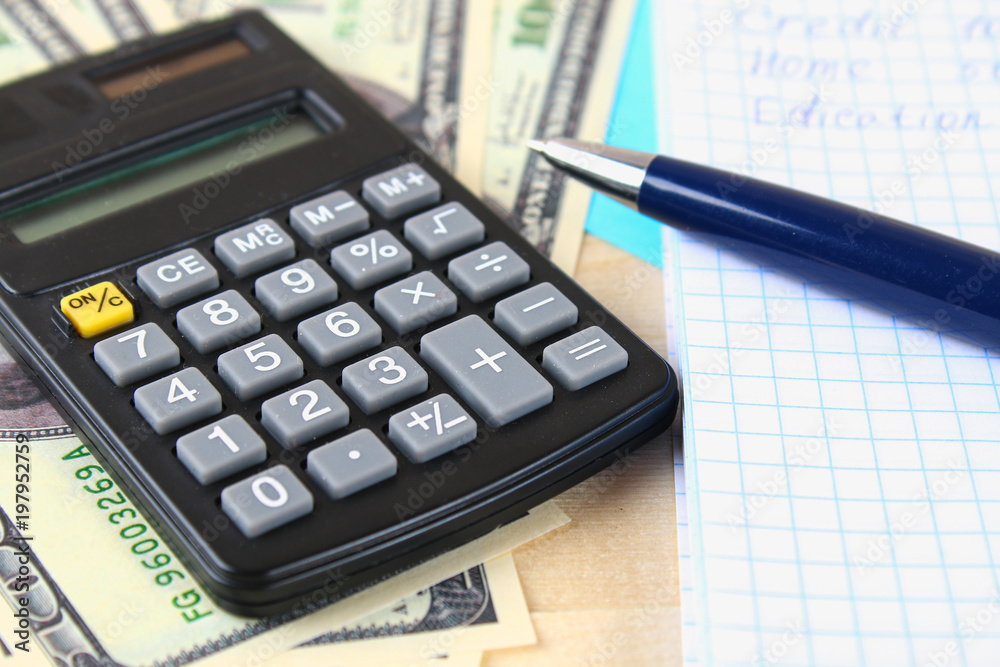 Finance concept : The United States hundred-dollar bills , calculator , bills. Finance concept : The United States hundred-dollar bills , calculator , bills.