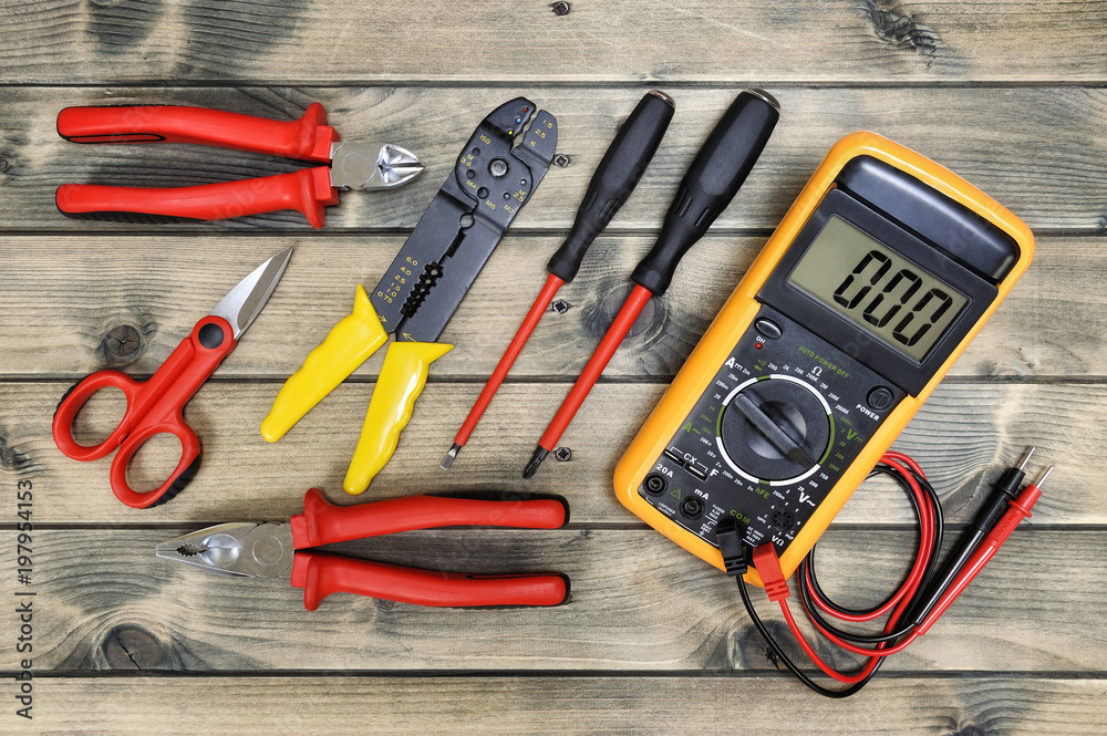 Top view of work tools for residential electrical installation on antique  wooden background. Stock Photo | Adobe Stock