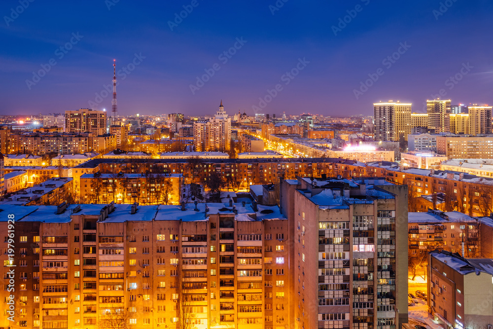 Aerial view of night Voronezh downtown. Voronezh cityscape at blue hour. Urban lights, modern houses, television tower