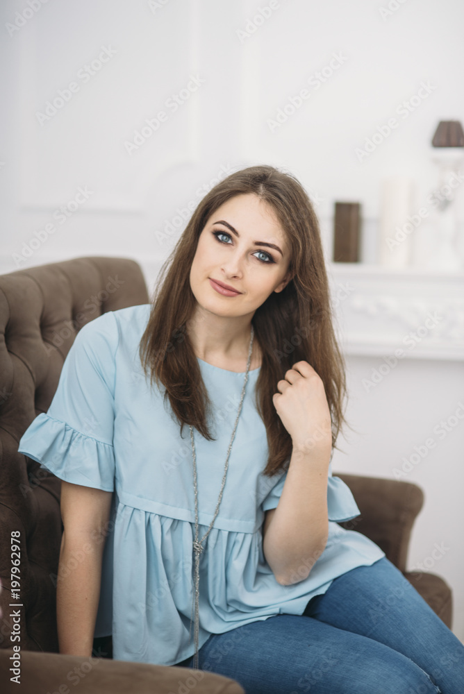 beautiful young stylish woman is sitting on the sofa hands beautiful young stylish woman is sitting on the sofa hands