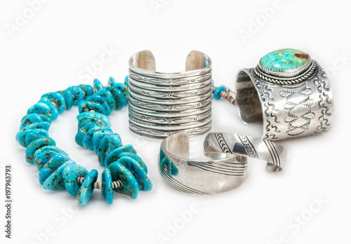 Collection of Sterling Silver Native American Bracelets with a Turquoise Nugget  Necklace with shallow depth of field.