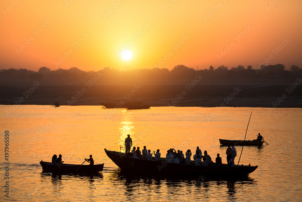 Dawn on the Ganges river, with the silhouettes of boats with pilgrims. Varanasi, India.