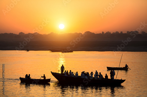 Dawn on the Ganges river, with the silhouettes of boats with pilgrims. Varanasi, India.