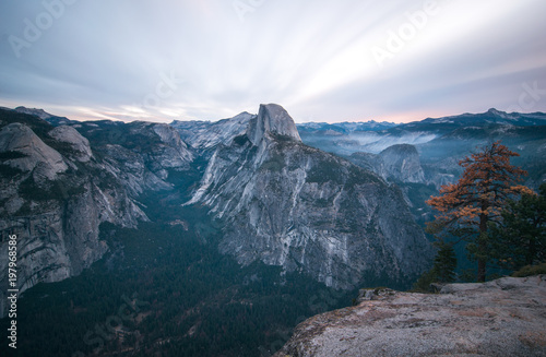 Long exposure of sunrise clouds climbing over Half Dome in Yosesmite