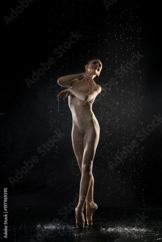 Ballerina in lingerie under water in the dark