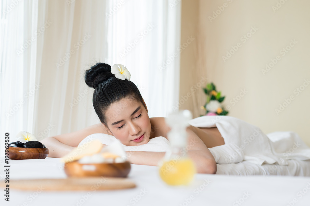 Beautiful Asian girl smile relaxing in the spa massage in salon Beautiful Asian girl smile relaxing in the spa massage in salon