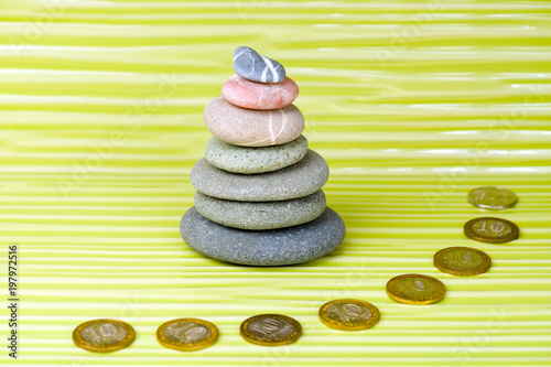 Canvas Print Multicolored zen stones and coins on a wavy surface