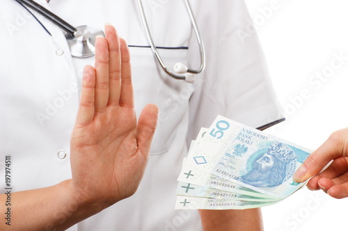 Woman doctor refusing bribes or kickbacks, concept of corruption
