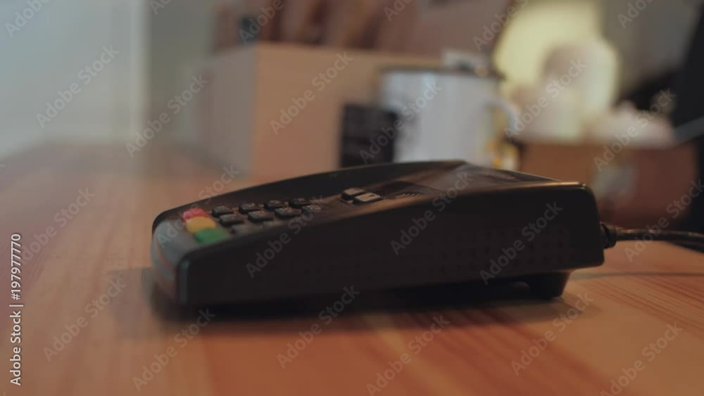 Non-cash transaction. Credit card payment in a shop. Close up photo of woman hand paying with credit card. Non-cash transaction. Credit card payment in a shop. Close up photo of woman hand paying with credit card.