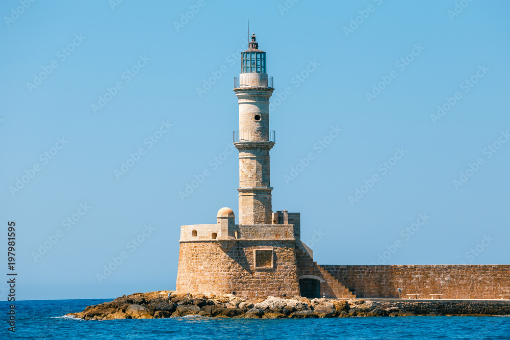 view of the entrance to Chania harbor with lighthouse, Crete, Greece