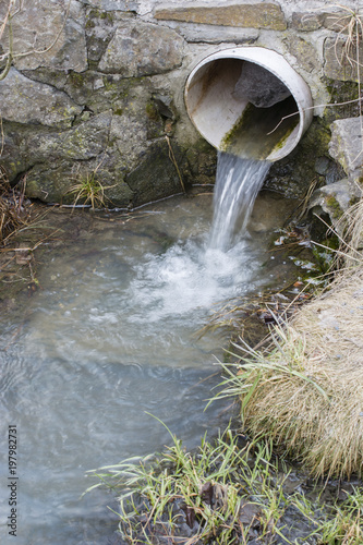 Принти на полотні Outflow of water from a plastic pipe outdoors.