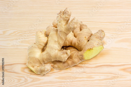 Two ginger roots on a wooden surface