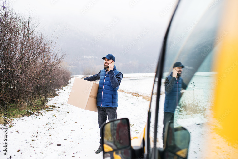 Delivery man delivering parcel box to recipient.