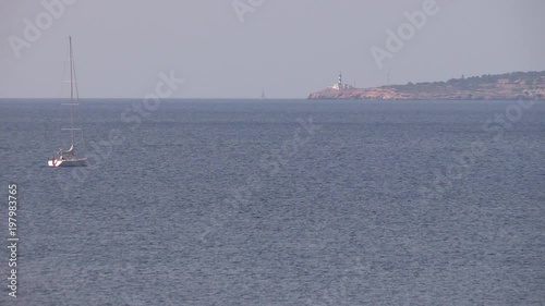 Mediterranean Sea with sail ship and lighthouse near Palma de Mallorca, Spain. photo