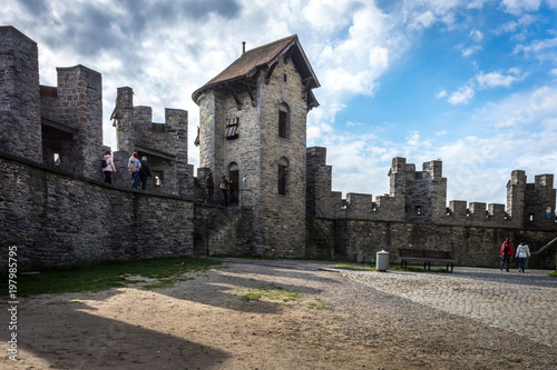 Obraz na plátně Toursists walk across the courtyard in the Gravensteen castle in Ghent, Belgium