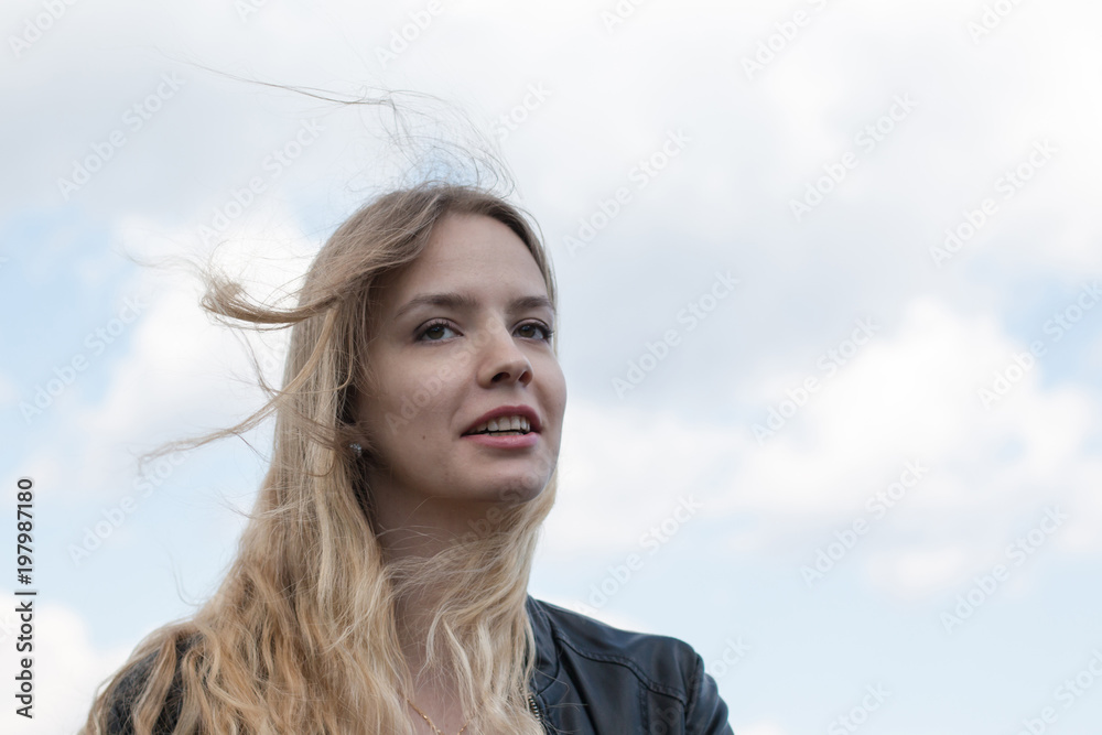 Girl with blond hair and blue sky and white cloud Girl with blond hair and blue sky and white cloud