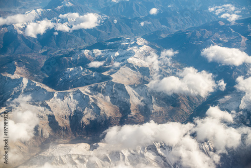 Dolomites Alps - Italy Mountains Under Clouds. View from Airplane.