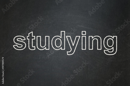 Education concept: text Studying on Black chalkboard background