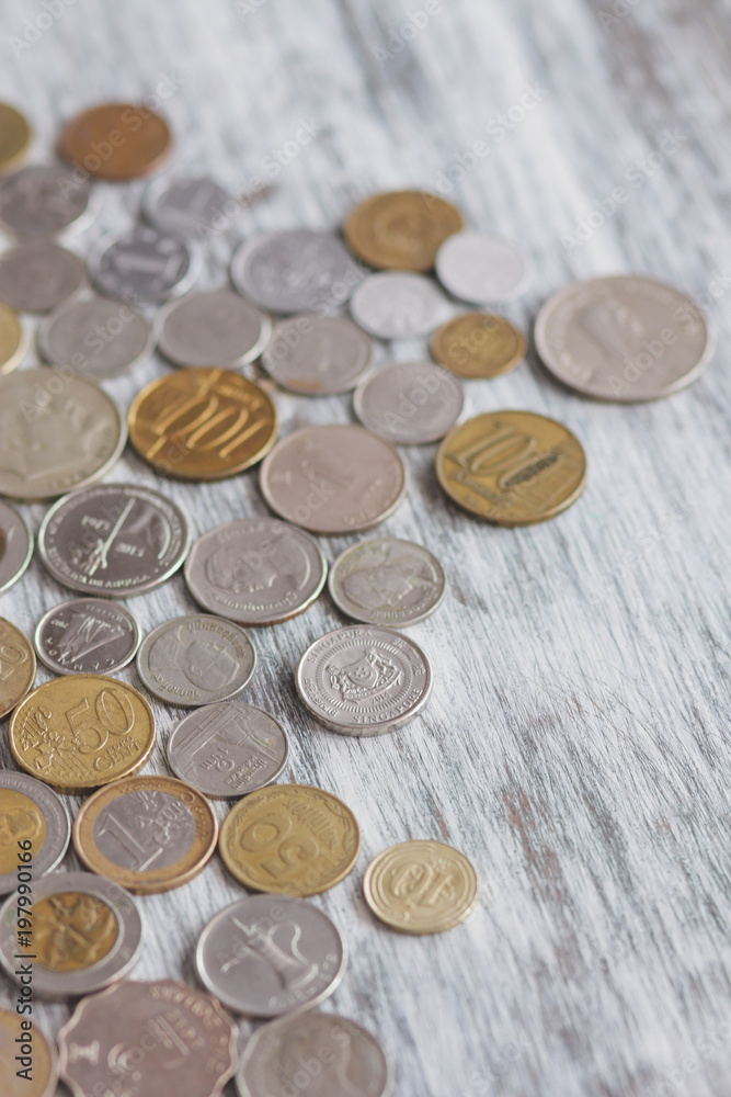 Different collector coins on the wooden background, soft focus background Different collector coins on the wooden background, soft focus background