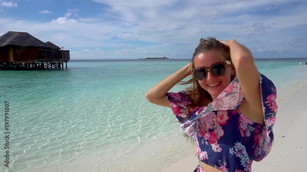 Happy woman walking, smiling and havng fun on ocean beach of Maldives Happy woman walking, smiling and havng fun on ocean beach of Maldives