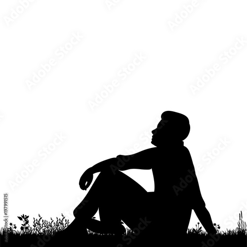 silhouette man sitting on the grass