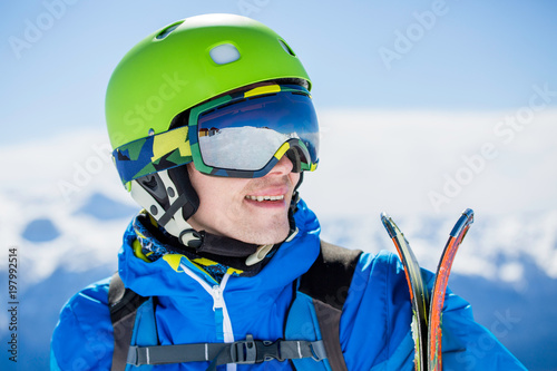 Portrait of sporty man with skis