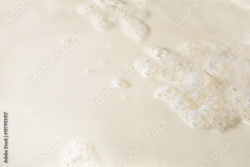 Milk texture background with foam and bubbles on the surface