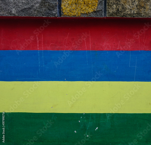 Mauritius flag painted on an old brick wall