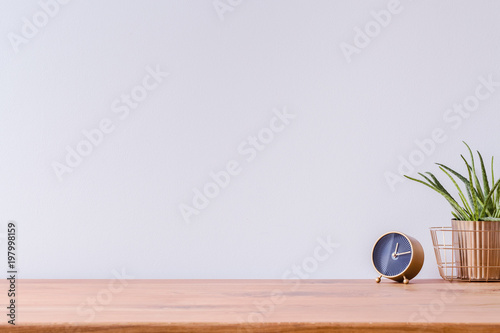 Wooden desk and empty wall photo