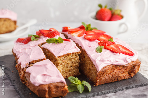 Yogurt pound cake for breakfast with pink cream and fresh strawberries. Light background, summer dessert. Breakfast concept.