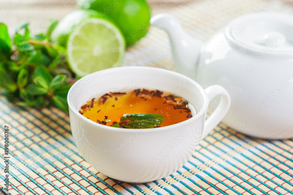 cup of black tea with mint leaves on a wooden table cup of black tea with mint leaves on a wooden table