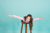 Happy child flying on chair, imagination