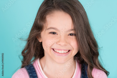 Beautiful little girl caucasian with long dark hair happy smiling