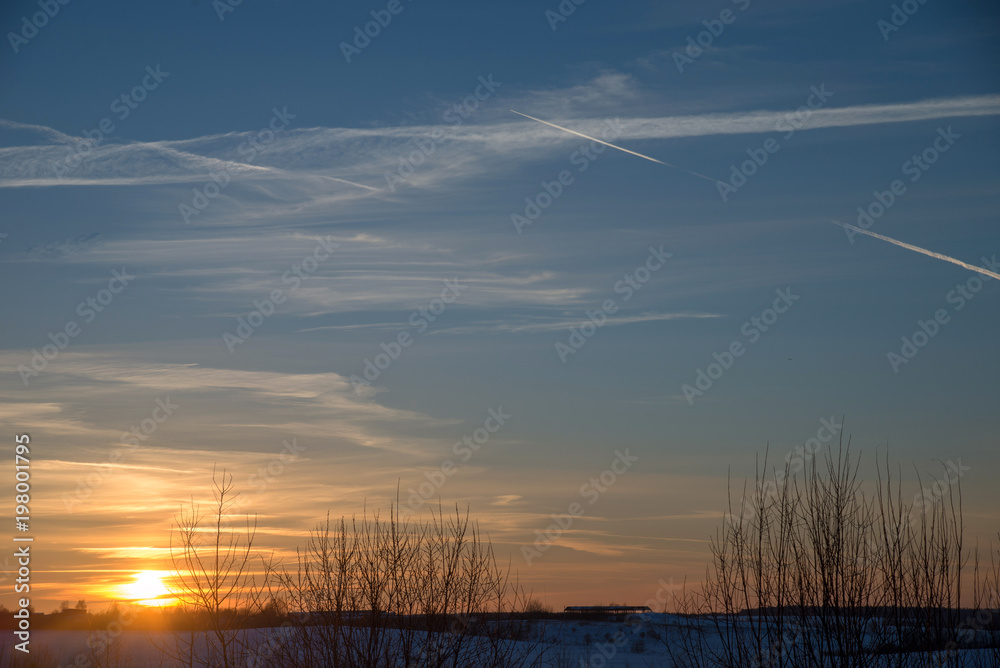 Sunset over village in winter