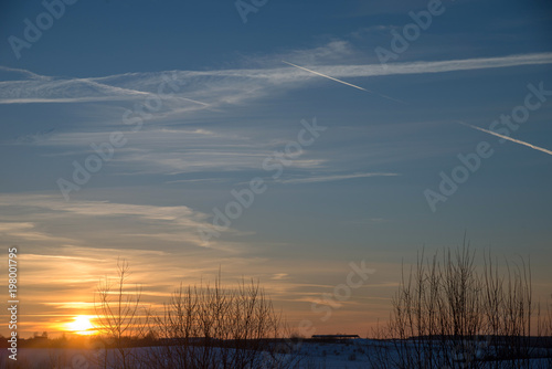 Sunset over village in winter