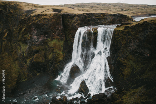 aerial view of spectacular Fagrifoss waterfall and rocks in iceland