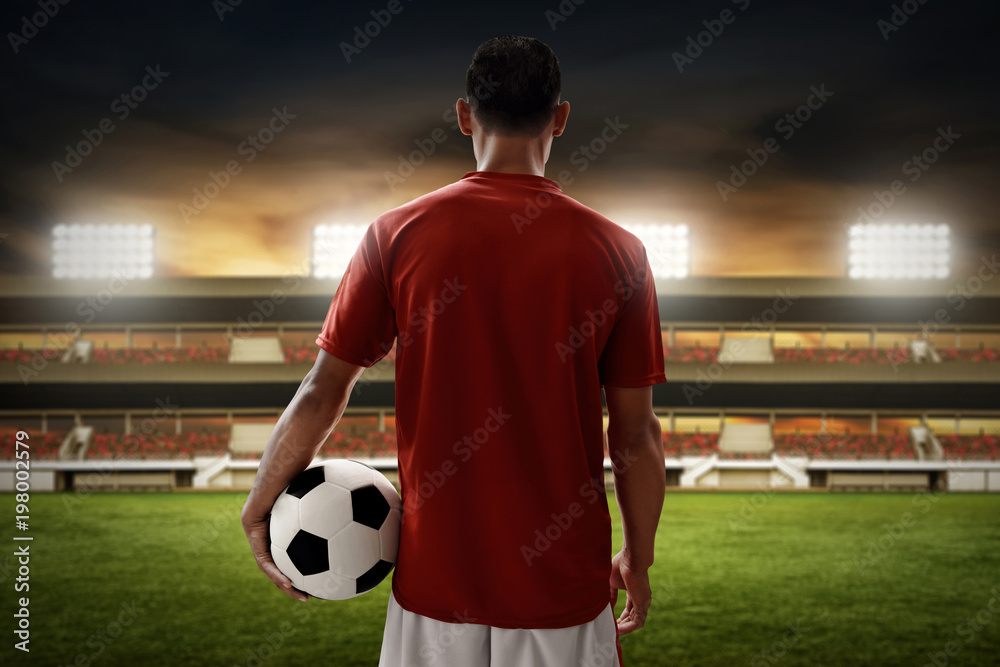 Fototapeta premium Soccer player holding soccer ball