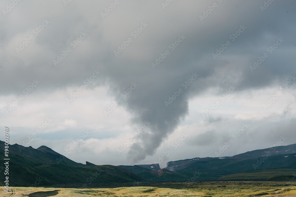 majestic icelandic landscape with steam from hot springs and cloudy sky majestic icelandic landscape with steam from hot springs and cloudy sky