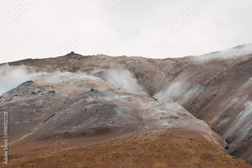 beautiful hills and hot spring with steam in iceland