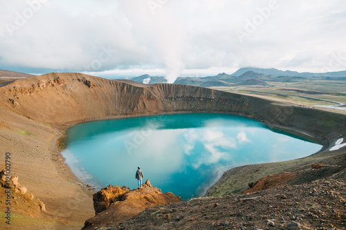 Fototapeta Naklejka Na Ścianę i Meble -  back view of man looking at majestic volcanic lake in iceland, krafla, lake viti