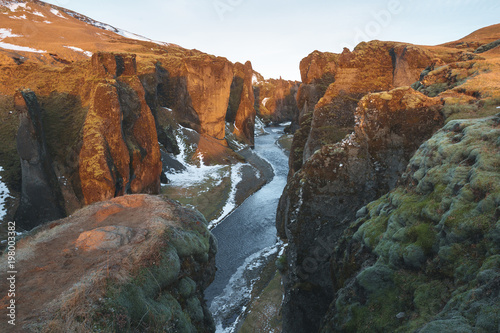 majestic landscape with river and rocky hills, fjadrargljufur, iceland